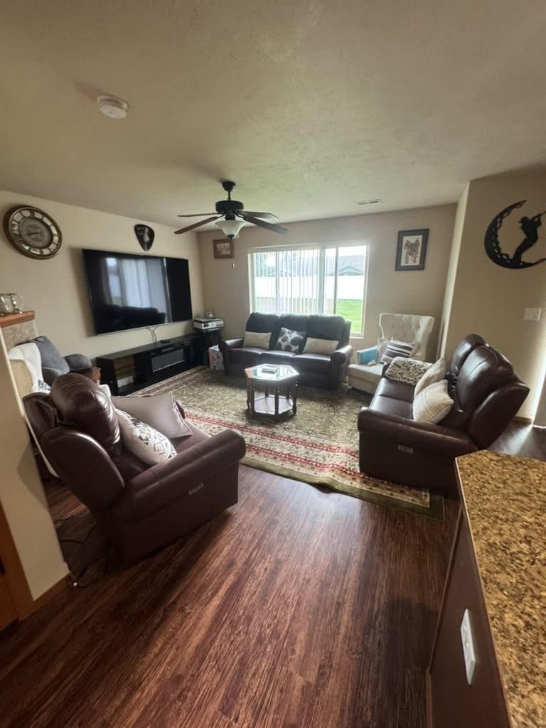 Comfortable living room with leather recliners and a large TV